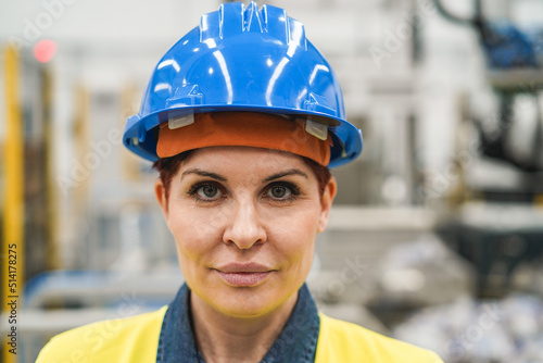 Senior engineer woman working inside robotic factory - Focus on face