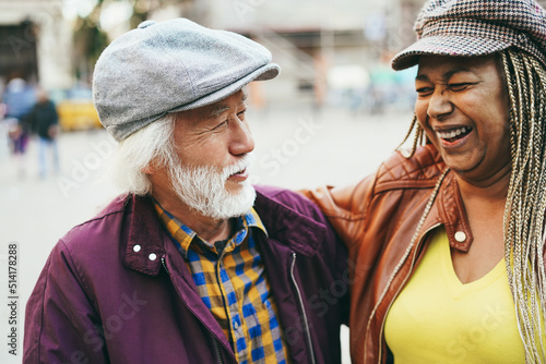 Photography Multiracial senior couple having fun outdoor with city in background - Soft focu