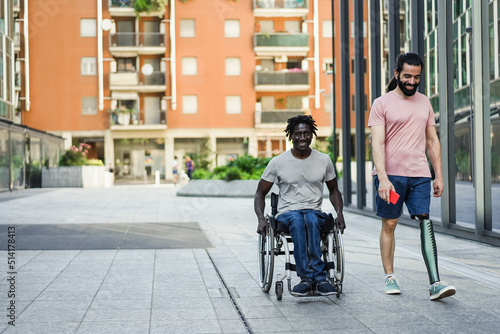 Multiracial friends with disability having fun outdoor - Focus on prosthetic leg