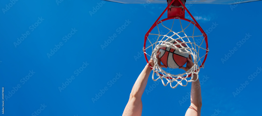 happy man with basketball ball on court. professional basketball player training outdoor. Horizontal poster design. Web banner header, copy space.