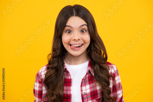 Funny kids face. Portrait of silly teenager child girl smiling and showing tongue in camera making funny faces.