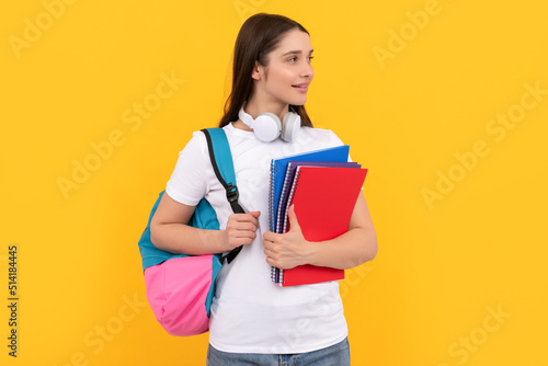 positive student hold notebook. girl holding notebook on yellow background. private teacher