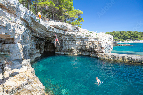 Croatia, Istria, Pula, coastline with rocks and cave photo