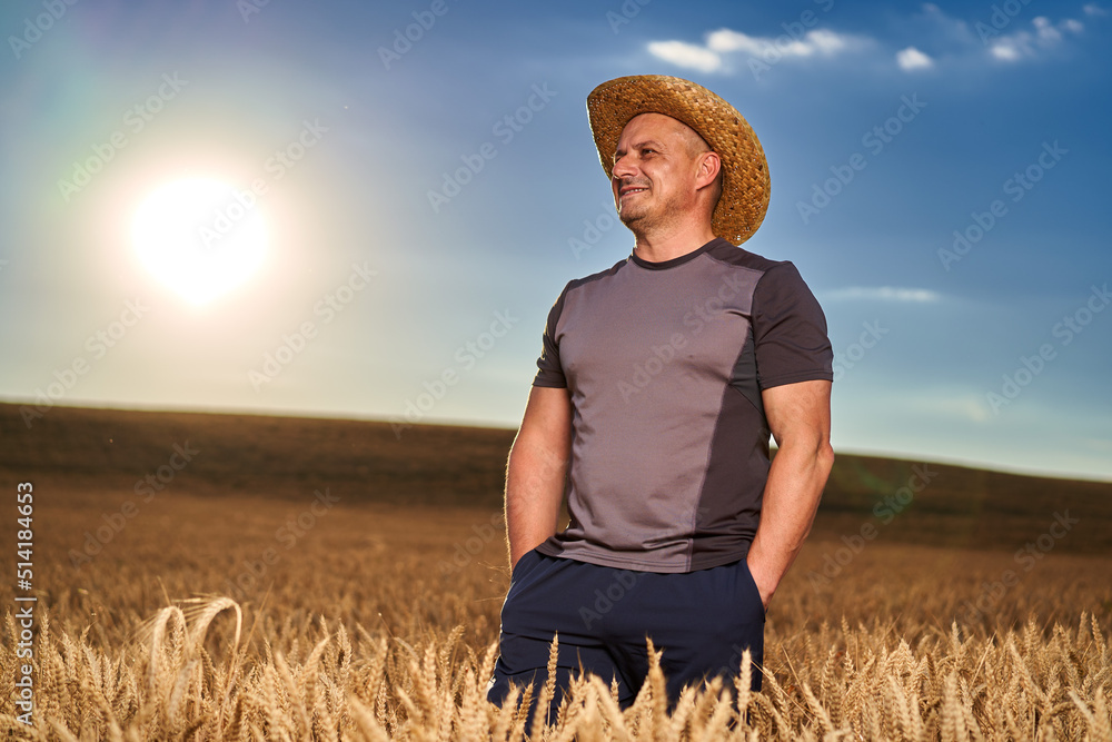 Obraz premium Happy farmer in a wheat field