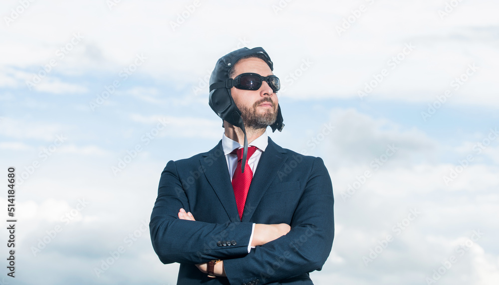 businessman in suit and pilot hat crossed hands on sky background businessman in suit and pilot hat crossed hands on sky background