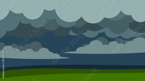 Gray stormy sky over green field