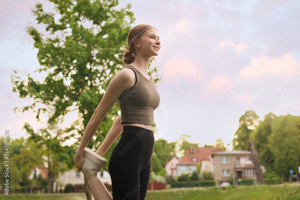 Teenage girl doing morning exercise in park, space for text Teenage girl doing morning exercise in park, space for text