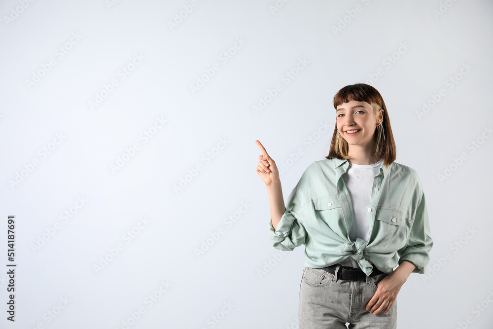 Beautiful young girl pointing on white background. Space for text Beautiful young girl pointing on white background. Space for text