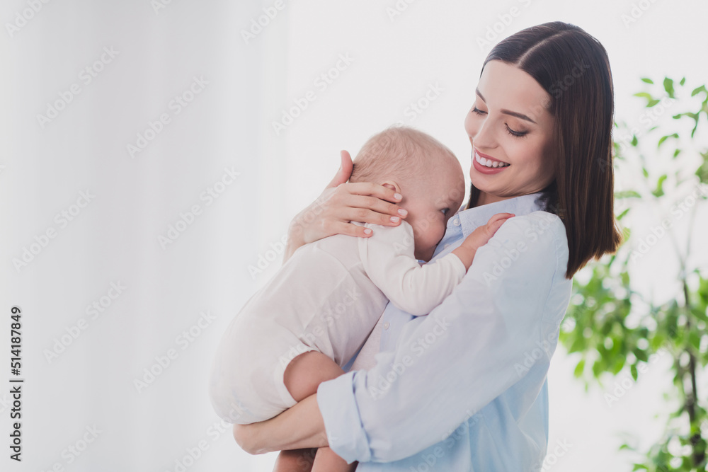 Portrait of attractive cheerful tender gentle woman mum holding small kid enjoying generation staying home indoors