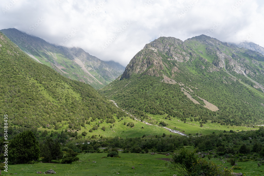 Landscape overlooking high green mountains and clouds Landscape overlooking high green mountains and clouds