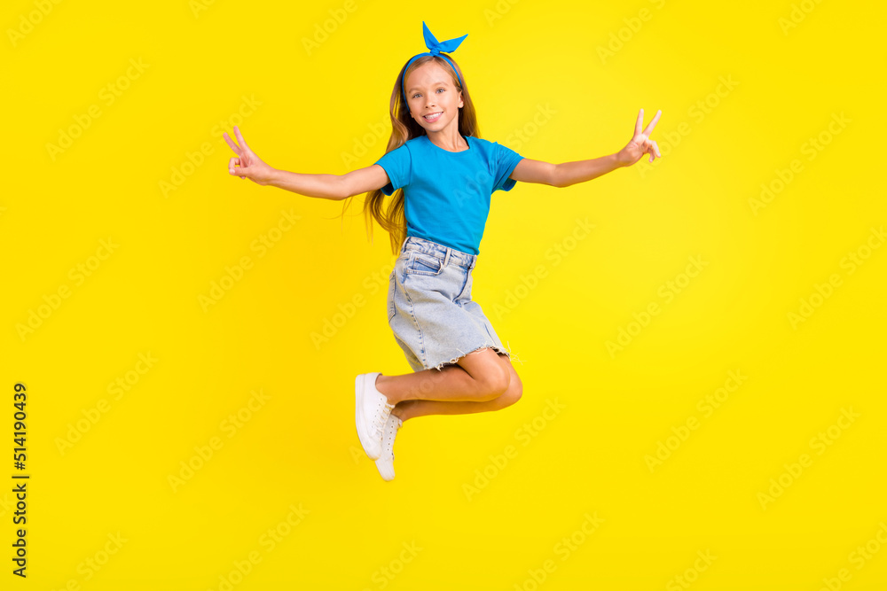 Full body photo of small friendly person jumping arms fingers demonstrate v-sign isolated on yellow color background