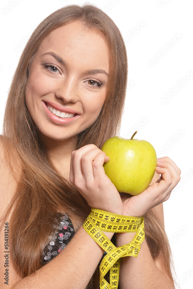 Portrait of beautiful young woman with green apple and measuring tape Portrait of beautiful young woman with green apple and measuring tape