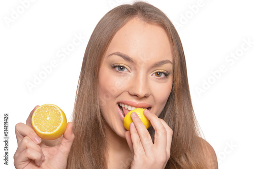 Portrait of beautiful young woman with lemon isolated