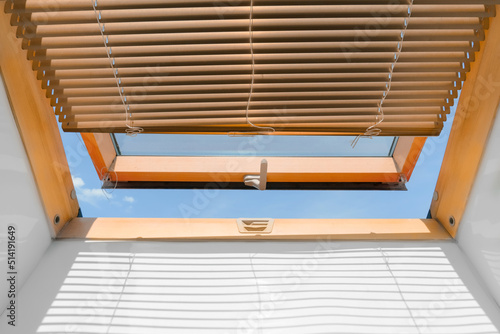 mansard roof window with shutter blinds.