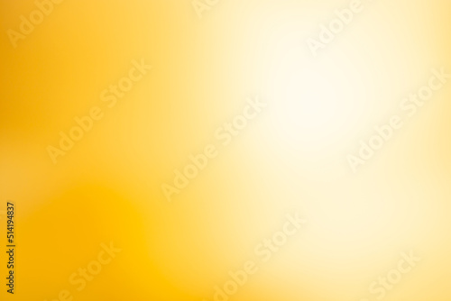 Abstract sunny bokeh blur golden shining background.