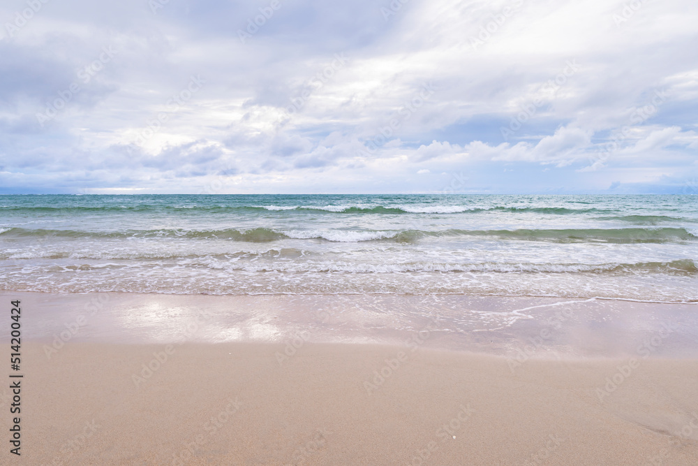 Panorama of a beautiful sand beach and turquoise water in Thailand. Holiday summer beach background.. Wave of the sea on the sand beach. Panorama of a beautiful sand beach and turquoise water in Thailand. Holiday summer beach background.. Wave of the sea on the sand beach.