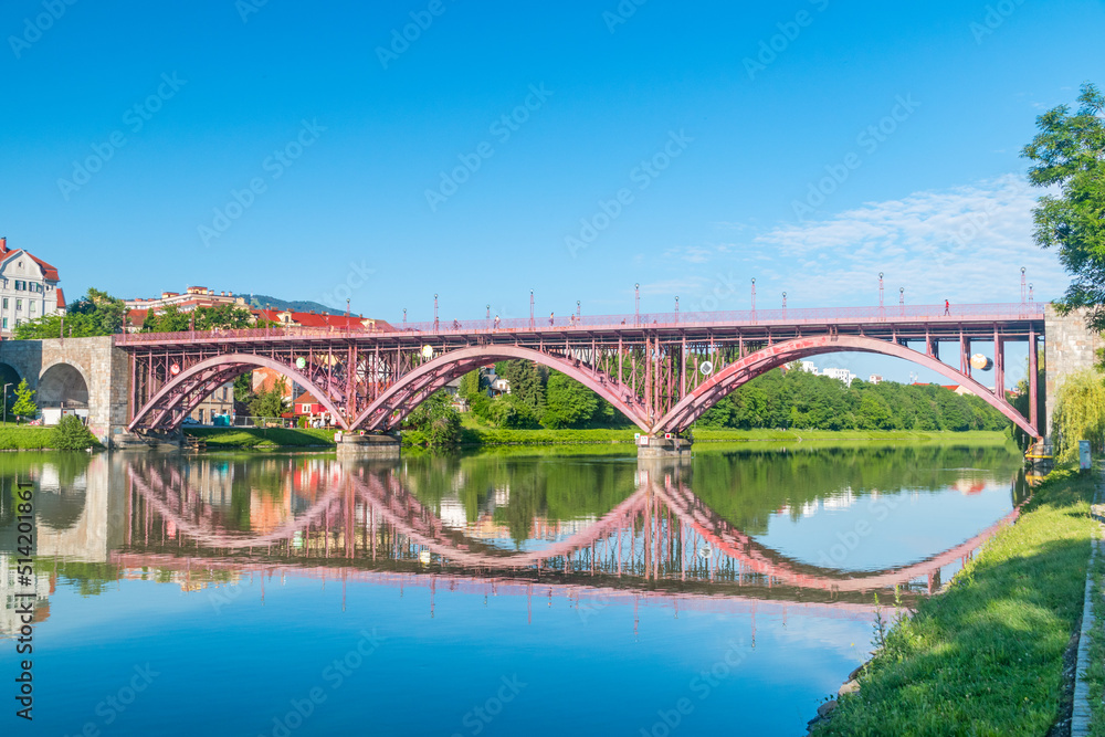 Maribor, Slovenia - June 2, 2022: Main Bridge (Glavni most) or Old Bridge (Slovene: Stari most) over Drava river in Maribor.