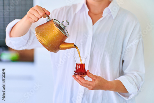 Female drinking traditional turkish tea