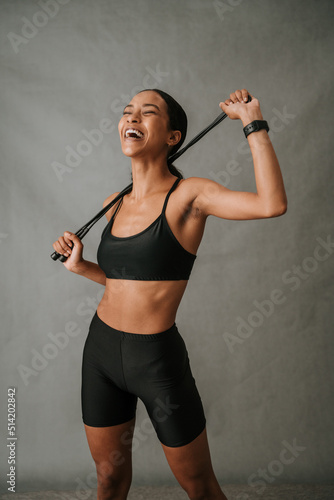 Young Multiethnic female holding her skipping rope 