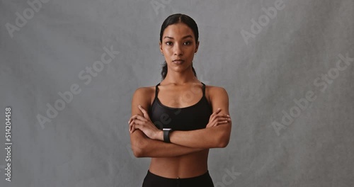 Serious African woman in workout clothing looking at camera in stduio photo
