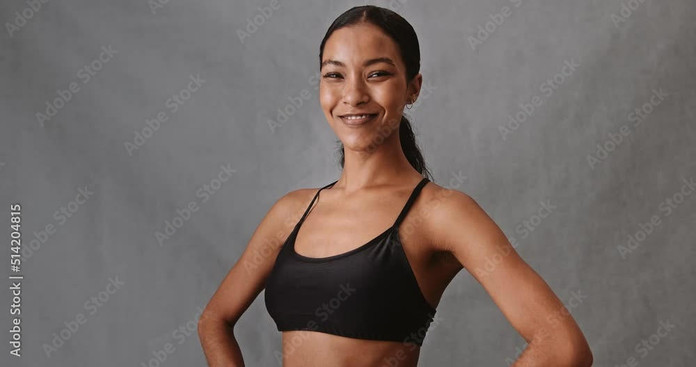 Young mixed race woman hands on hip smiling Young mixed race woman hands on hip smiling