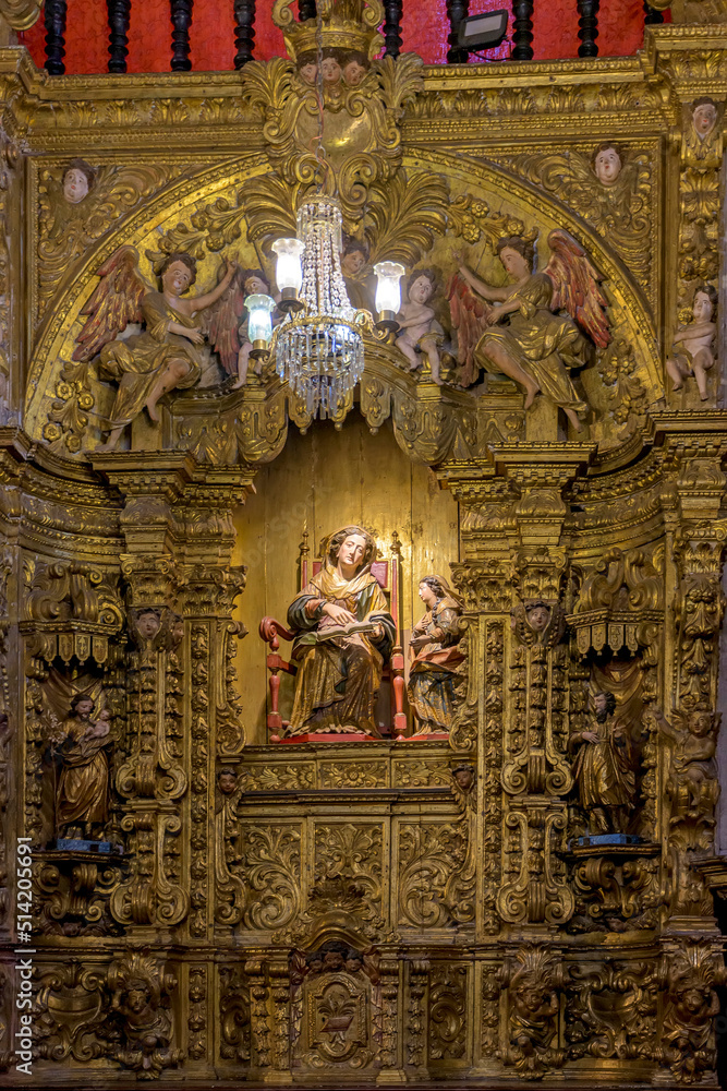Obraz premium Interior of a baroque church decorated with images of saints and walls with gold leaf ornaments in the historic city of Ouro Preto, Minas Gerais