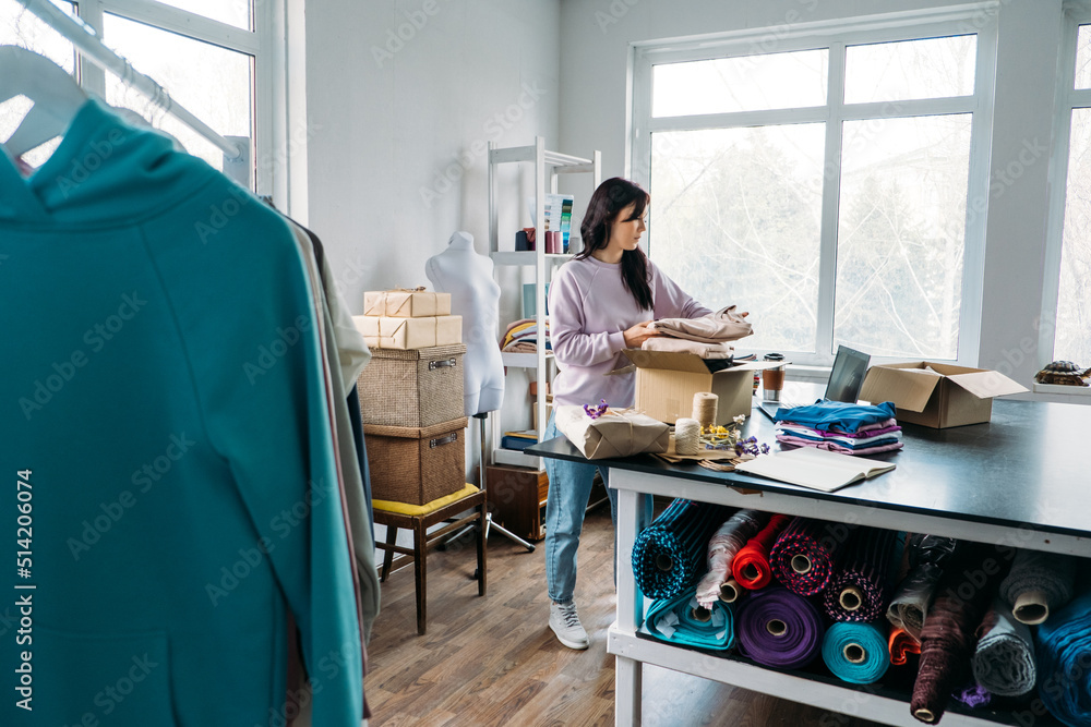 Obraz premium Dropshipping, small business, ecommerce businesses. Female online store clothing shop owner packing package