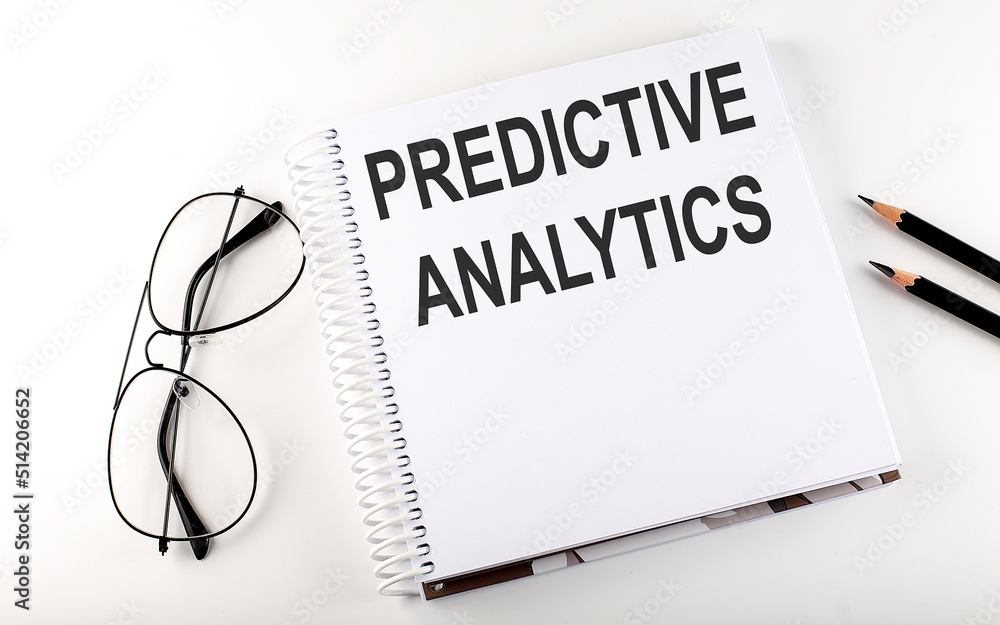 Notepad with text PREDICTIVE ANALYTICS. White background. Business concept Notepad with text PREDICTIVE ANALYTICS. White background. Business concept