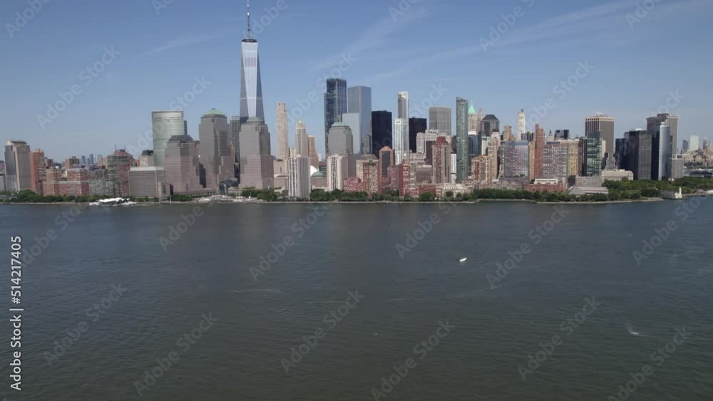 Aerial view of skyscrapers of lower Manhattan, in sunny NYC, USA - rising, drone shot