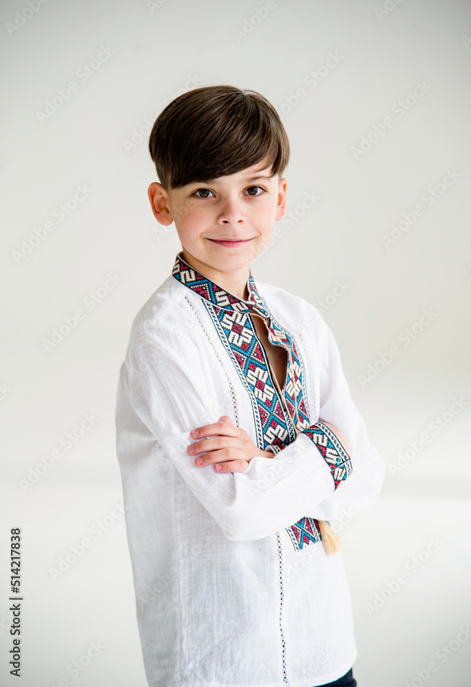 portrait of happy smiling boy in beautiful ukrainian embroidery in white studio portrait of happy smiling boy in beautiful ukrainian embroidery in white studio