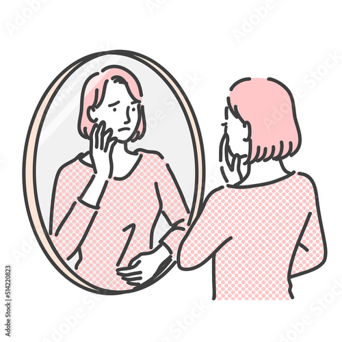 不安げに鏡を見ている女性
