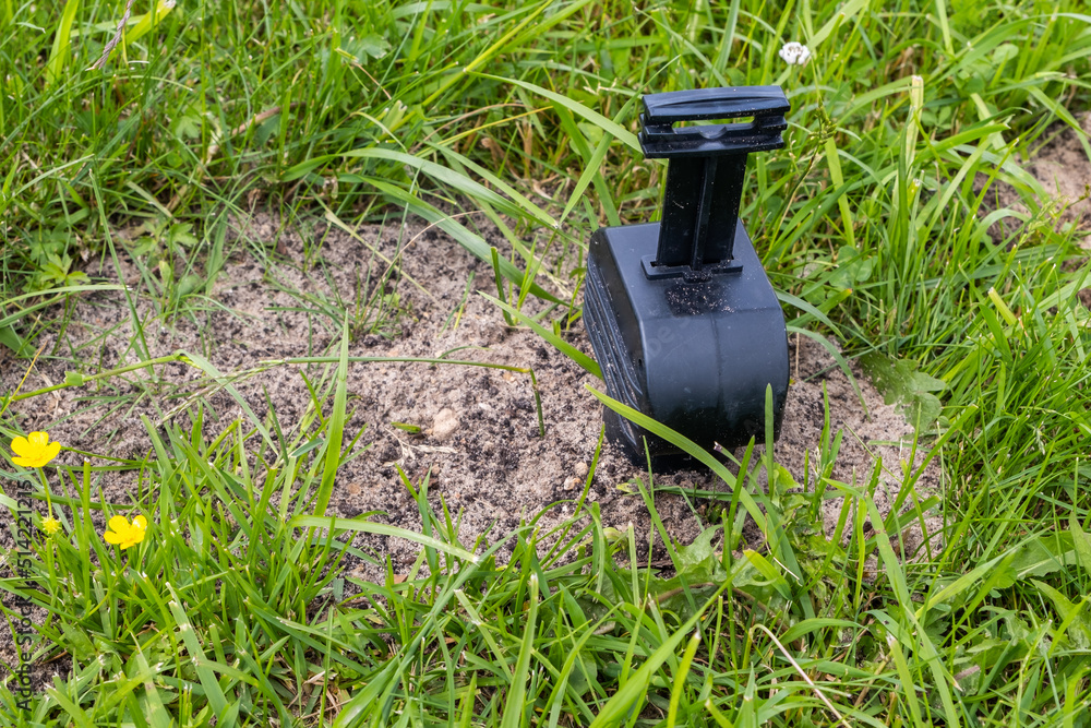 Mole trap set on the lawn, close-up image Mole trap set on the lawn, close-up image