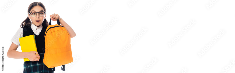 Shocked pupil holding books and backpack isolated on white, banner. Shocked pupil holding books and backpack isolated on white, banner.
