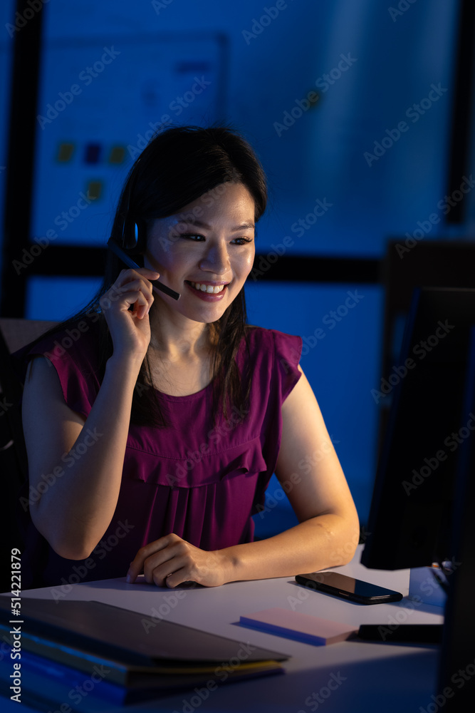 © Wavebreak Media - Asian female customer representative talking over headset and using computer at desk in office © Wavebreak Media - Asian female customer representative talking over headset and using computer at desk in office