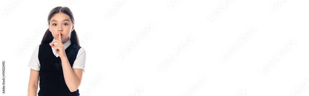 Schoolchild showing secret gesture at camera isolated on white, banner. Schoolchild showing secret gesture at camera isolated on white, banner.