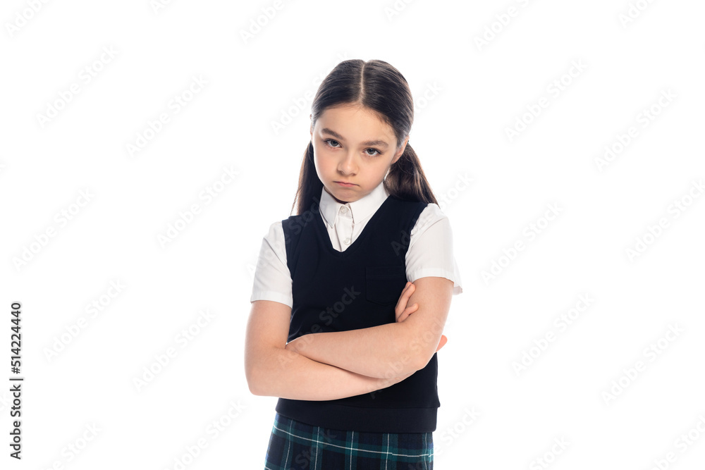 Upset schoolgirl crossing arms and looking at camera isolated on white. Upset schoolgirl crossing arms and looking at camera isolated on white.
