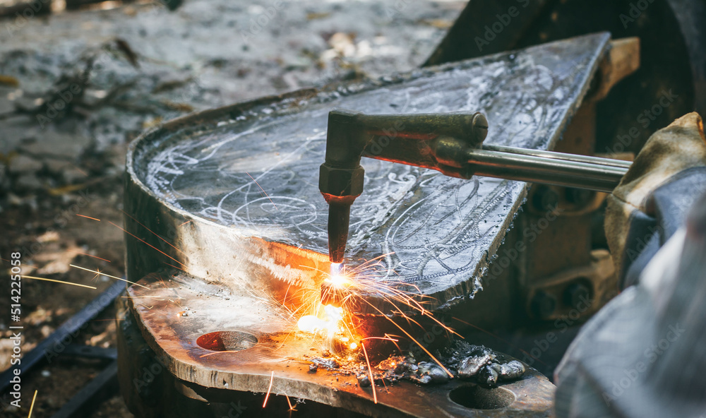 Close up hand heavy industrial worker is working on metal work factory