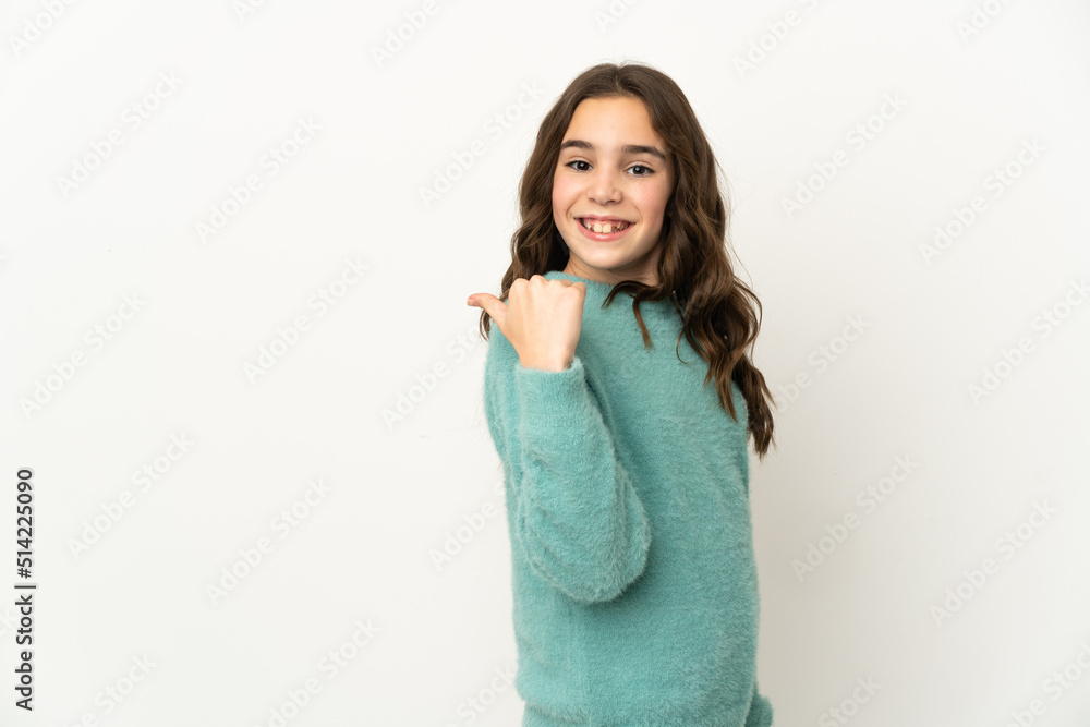 Little caucasian girl isolated on white background pointing to the side to present a product Little caucasian girl isolated on white background pointing to the side to present a product