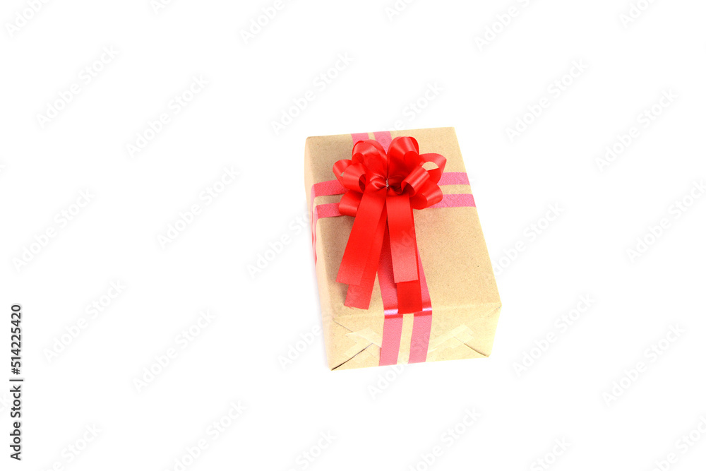 Brown craft gift box with red ribbon bow isolated on white background. Brown craft gift box with red ribbon bow isolated on white background.