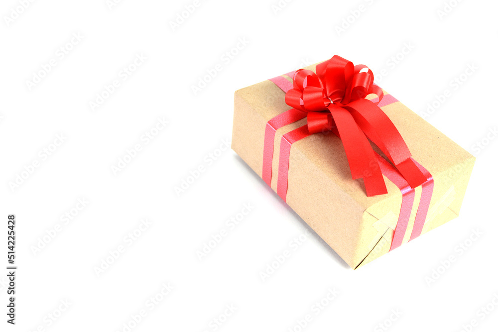 Brown craft gift box with red ribbon bow isolated on white background. Brown craft gift box with red ribbon bow isolated on white background.