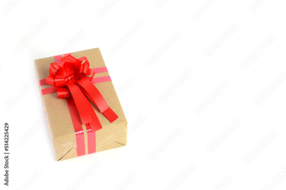Brown craft gift box with red ribbon bow isolated on white background. Brown craft gift box with red ribbon bow isolated on white background.