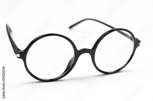Stylish glasses for vision in a black round frame on a white background