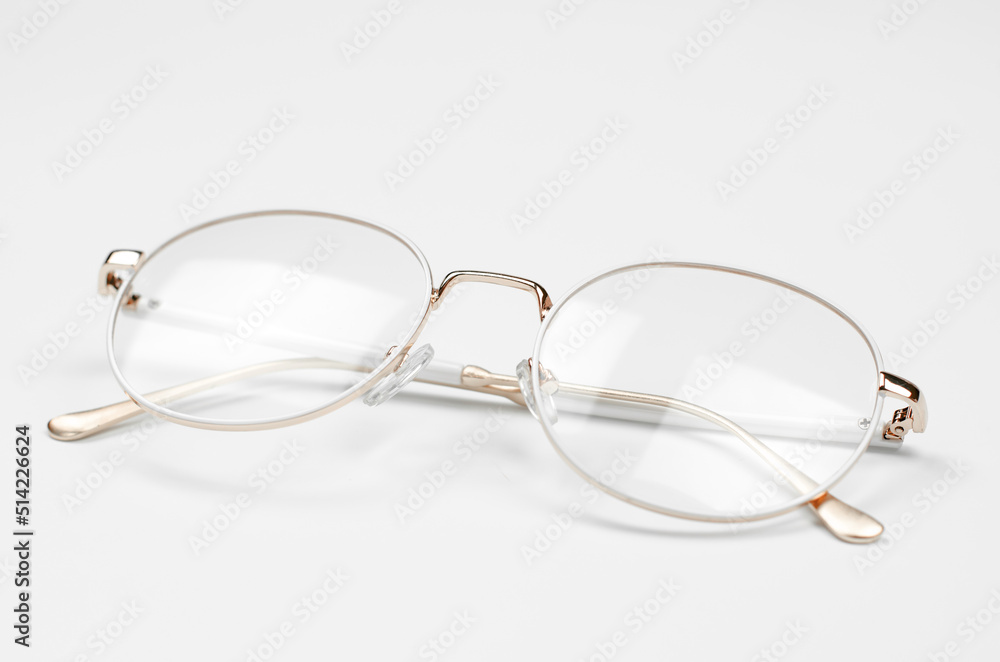 Stylish eyeglasses on a white background. Iron frame glasses Stylish eyeglasses on a white background. Iron frame glasses