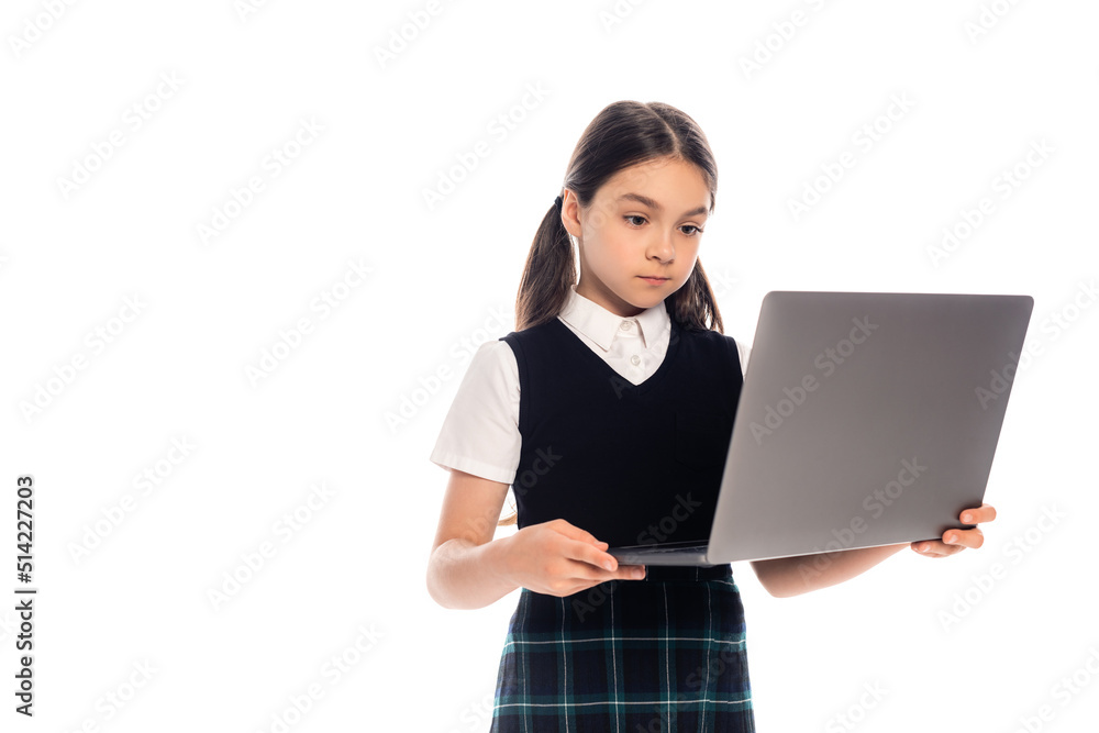 Brunette schoolkid holding laptop isolated on white. Brunette schoolkid holding laptop isolated on white.