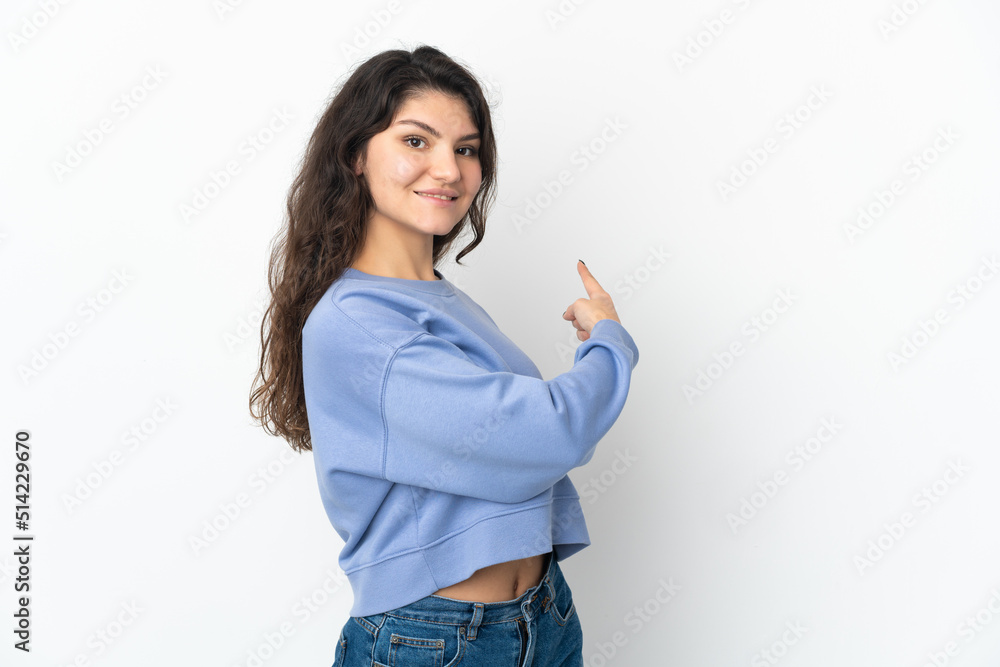 Teenager Russian girl isolated on white background pointing back Teenager Russian girl isolated on white background pointing back