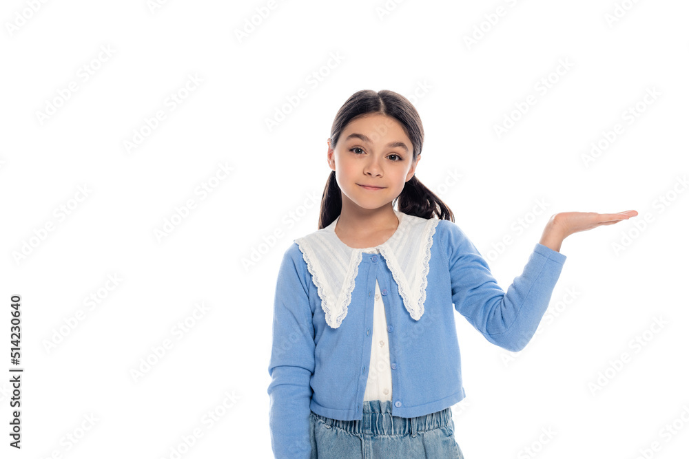 Positive schoolgirl pointing with hand and looking at camera isolated on white. Positive schoolgirl pointing with hand and looking at camera isolated on white.