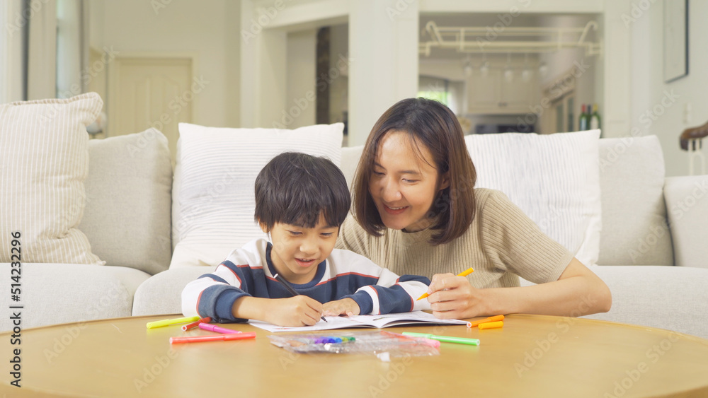Portrait of happy smiling Asian Family. A student drawing a picture at home or house in family relationship. Love of mother, and son. People lifestyle. Education activity. Portrait of happy smiling Asian Family. A student drawing a picture at home or house in family relationship. Love of mother, and son. People lifestyle. Education activity.