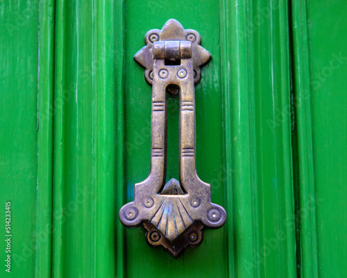 Ornate Door Knocker on a Green Door photo