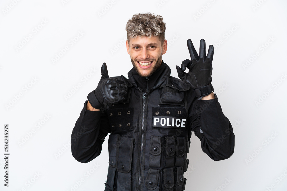 SWAT caucasian man isolated on white background showing ok sign and thumb up gesture SWAT caucasian man isolated on white background showing ok sign and thumb up gesture
