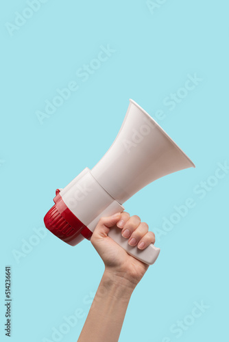 Fotografía Megaphone in woman hands on a white background.